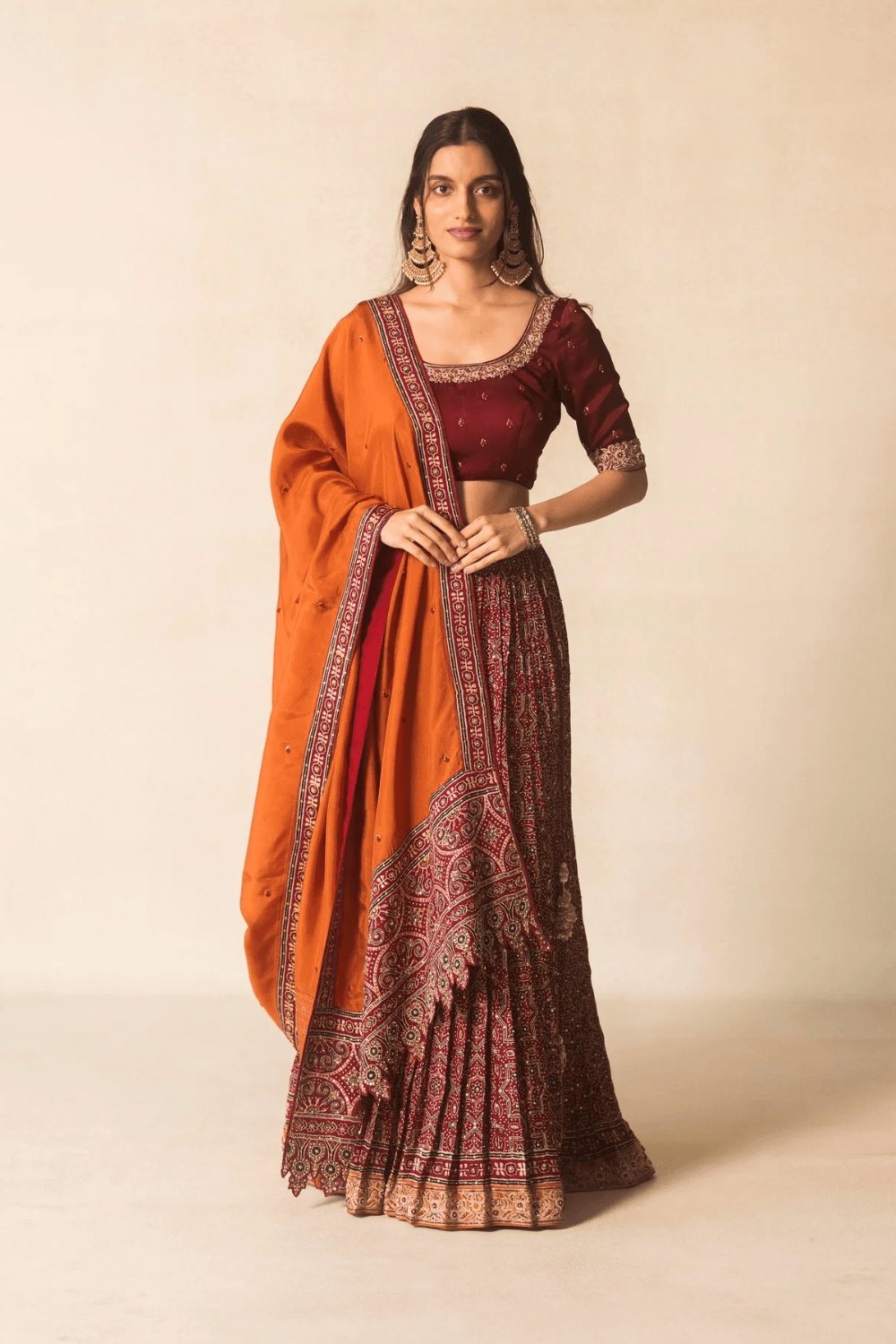 Maroon Ajrakh bandhej lehenga with orange dupatta
