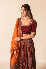 Maroon Ajrakh bandhej lehenga with orange dupatta
