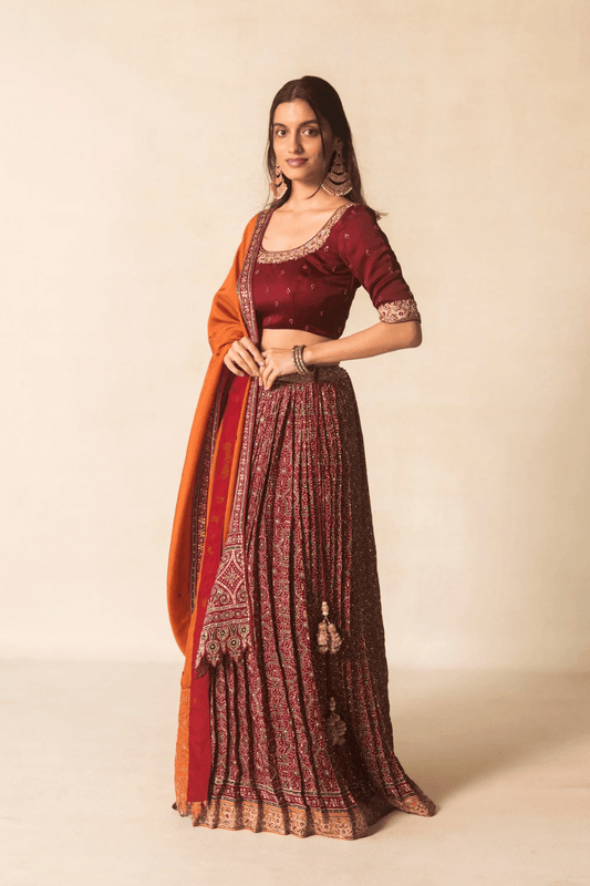 Maroon Ajrakh bandhej lehenga with orange dupatta