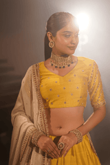 Radiant yellow silk lehenga and blouse with georgette dupatta